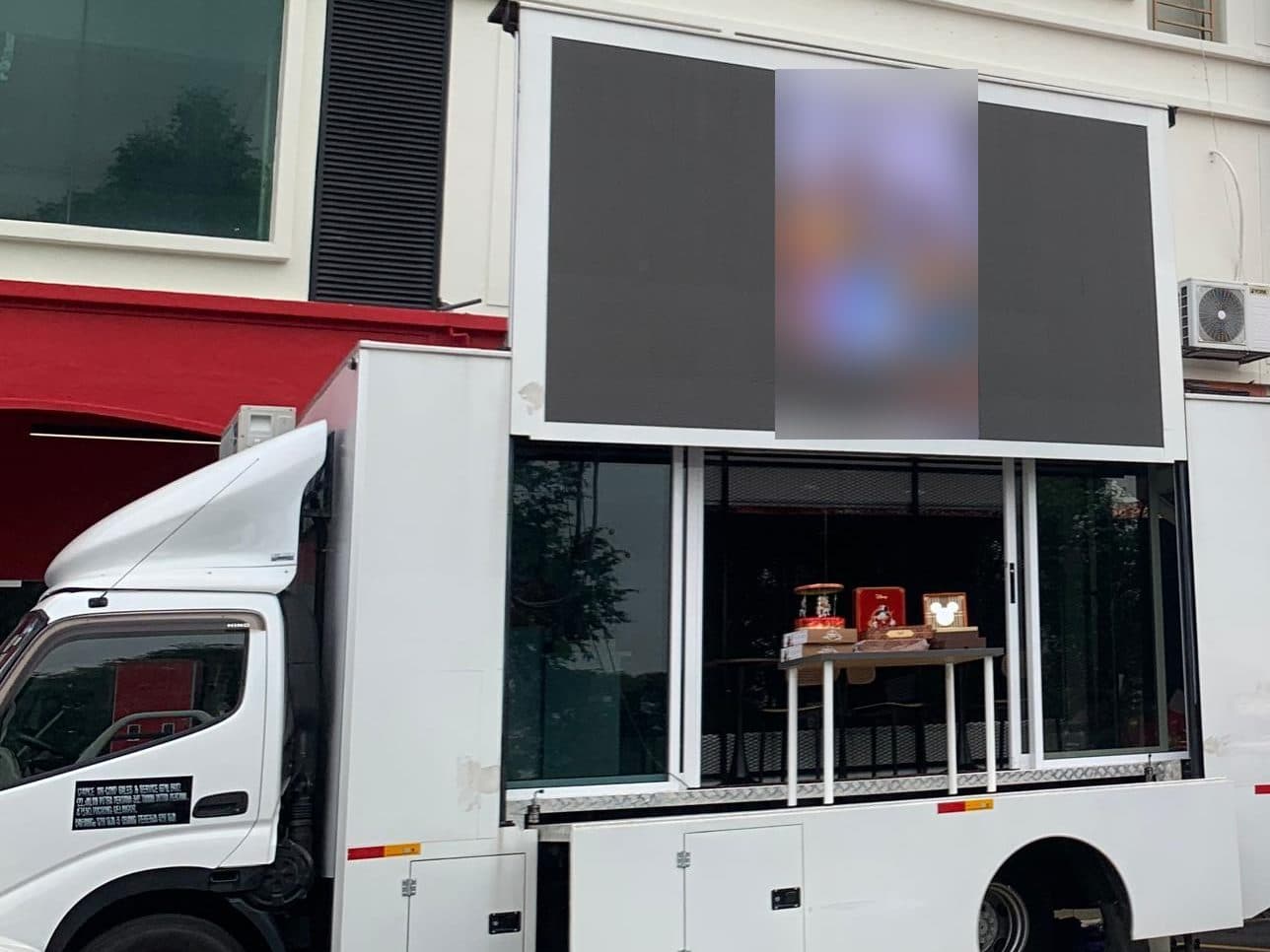 LED truck stationed outside a store during a grand opening