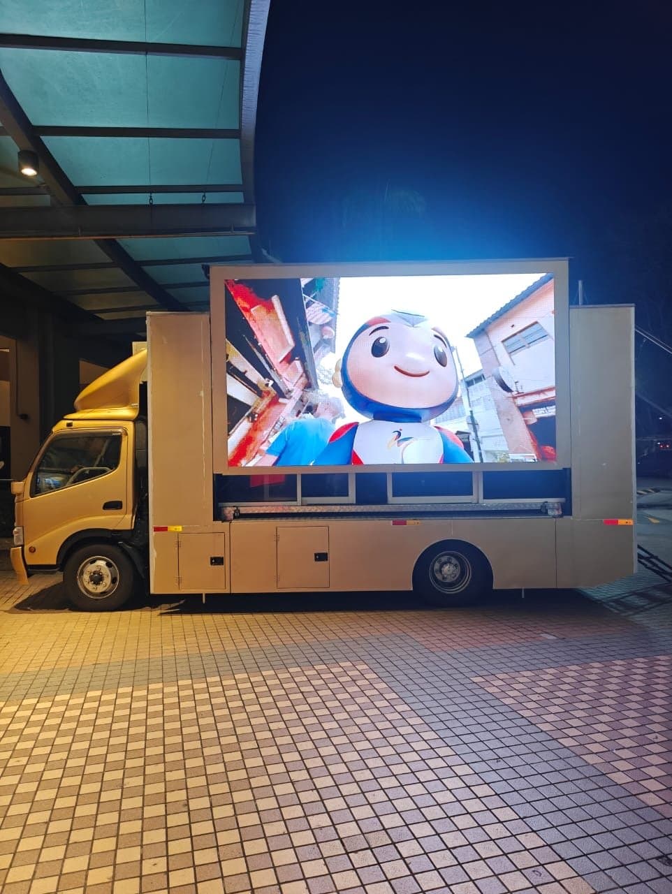 LED truck showing the SEA Games mascot on its screen at night