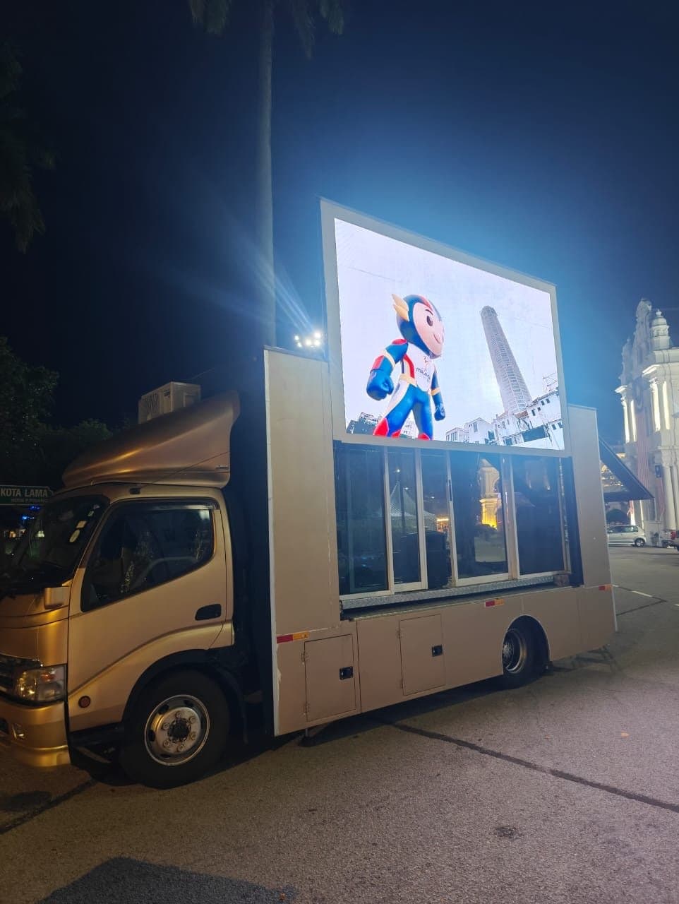 LED truck at a night stop, its screen showing the SEA Games mascot