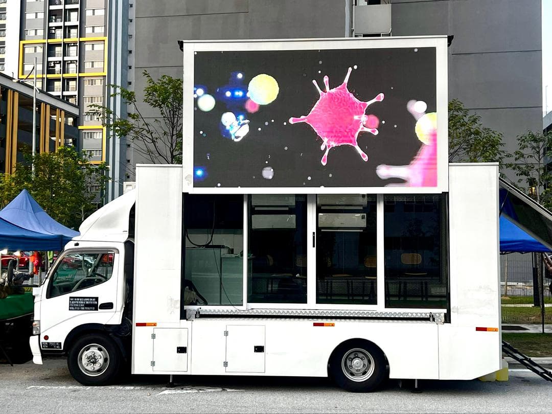 LED truck parked near a property sales gallery